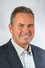 Smiling man in plaid shirt and suit jacket