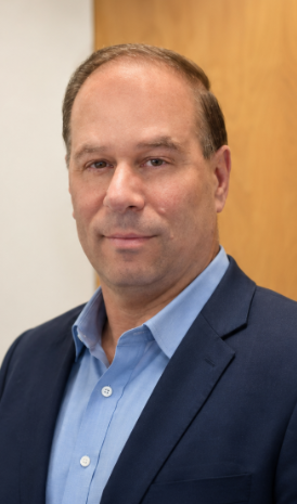 man in blue shirt and navy jacket